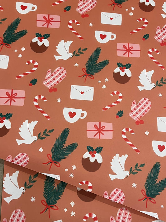 Christmas-themed wrapping paper with presents, candy canes, doves, and pine cones on a brown background.
