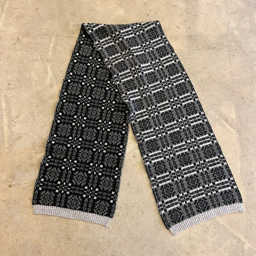 grey, white and black scarf on a beige background 