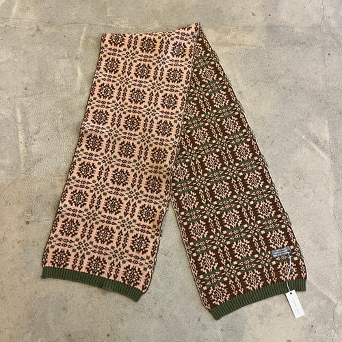 Pink, brown and green scarf on a beige background 