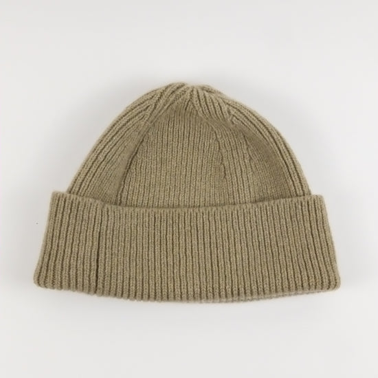 Khaki knit beanie on a white background