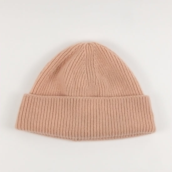 pink knit beanie on a white background