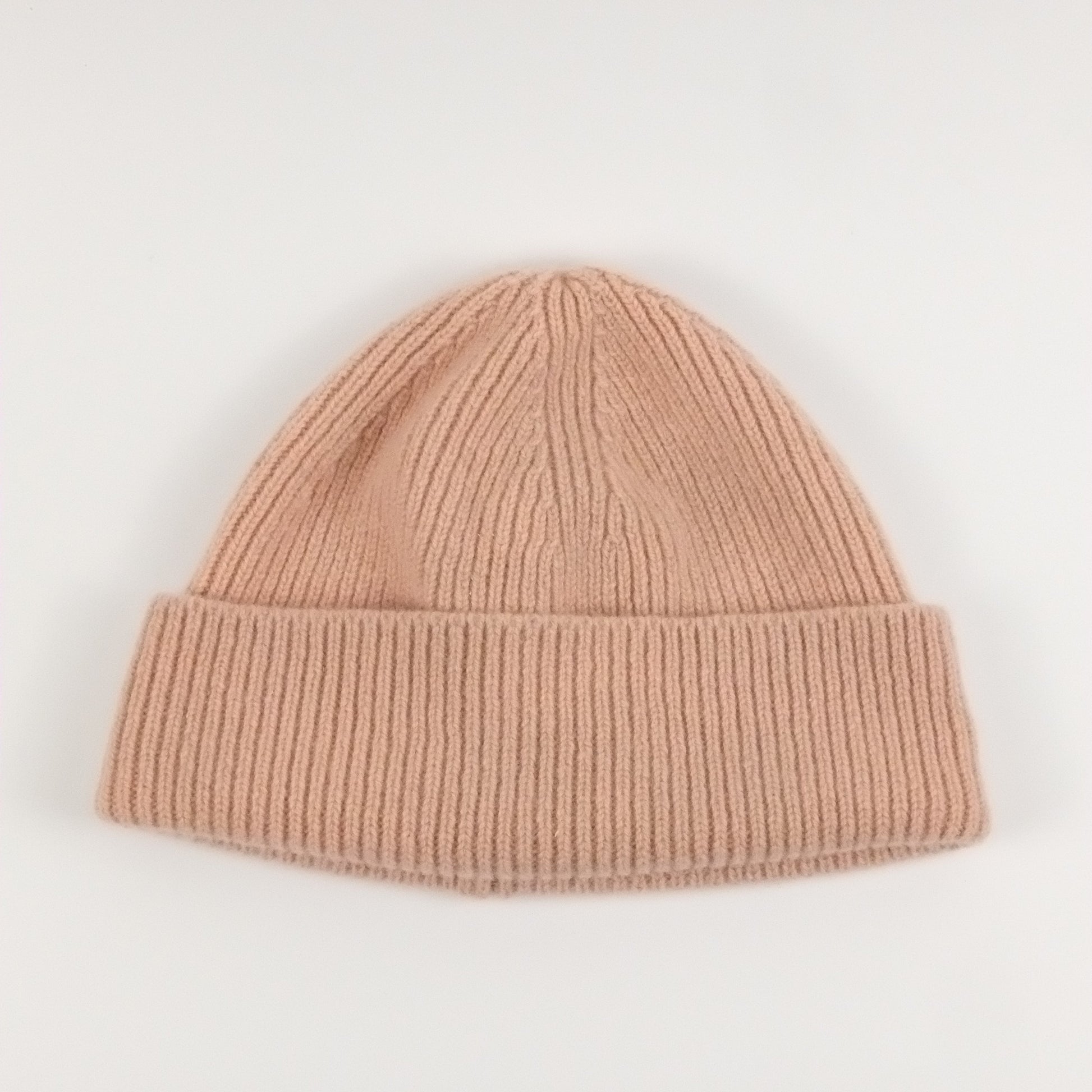 pink knit beanie on a white background