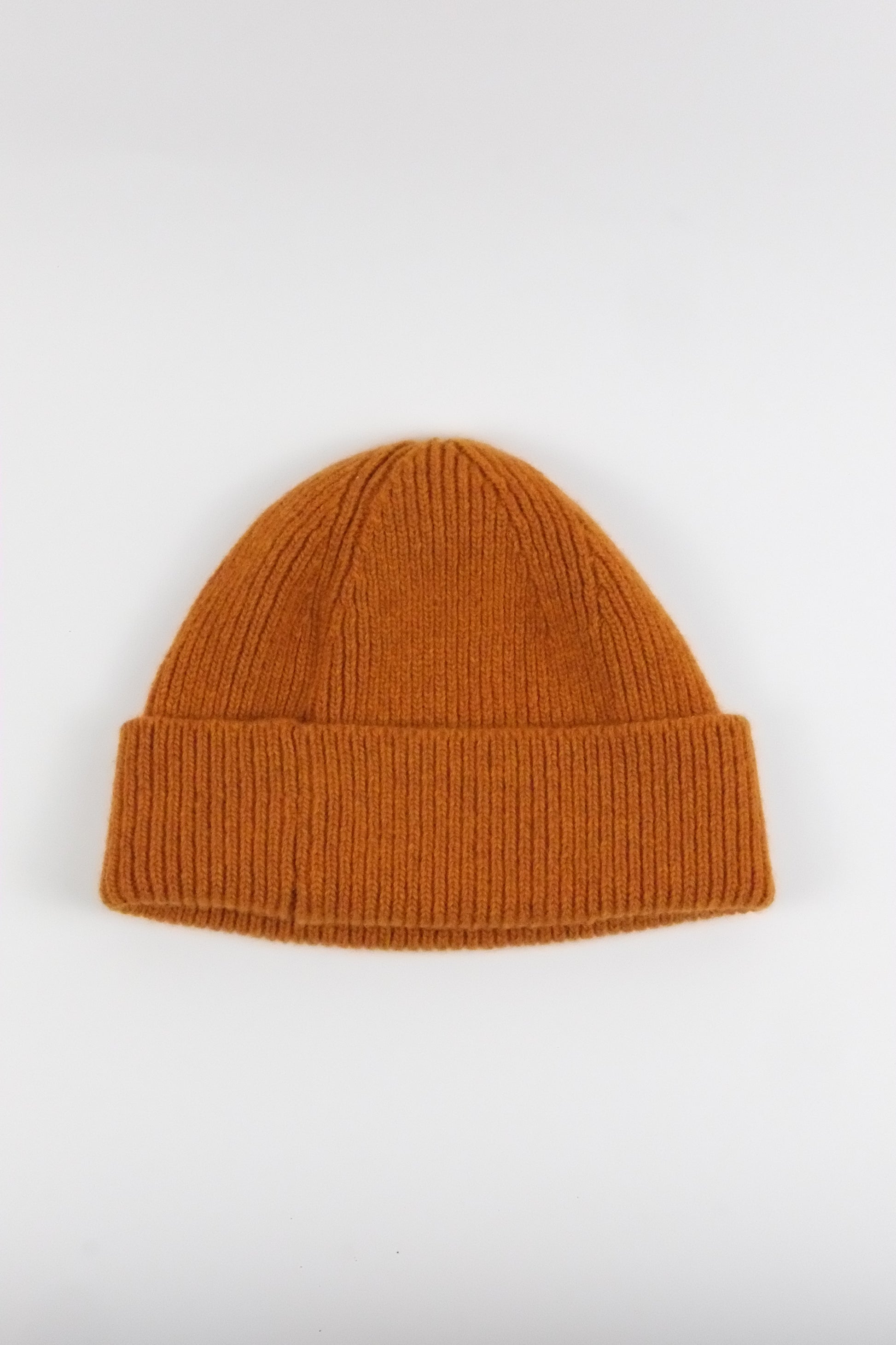 orange knit beanie on a white background