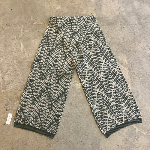 Fern pattern ivory and green scarf on a concrete background
