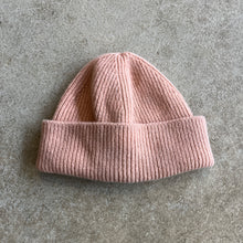Load image into Gallery viewer, Pink knit beanie on a grey surface

