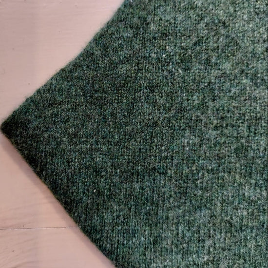 A green triangle scarf on a white background 