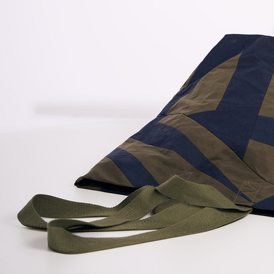 A bag with greeen straps on a white background