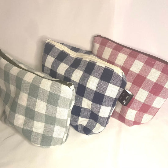 Three checkered pouches in different patterns on a white background