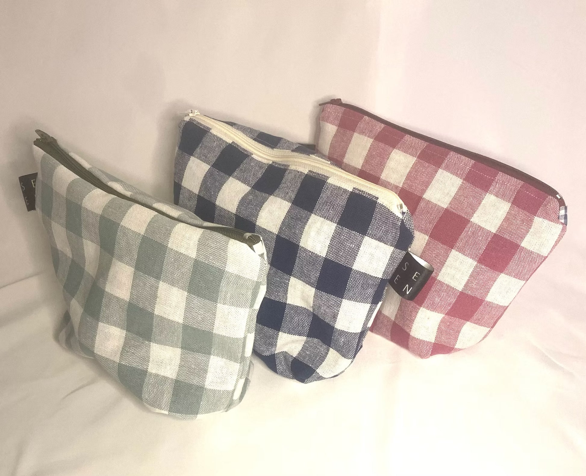 Three checkered pouches in different patterns on a white background