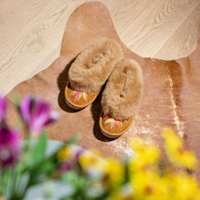 Load image into Gallery viewer, Brown slippers on a wooden floor with flowers in the foreground
