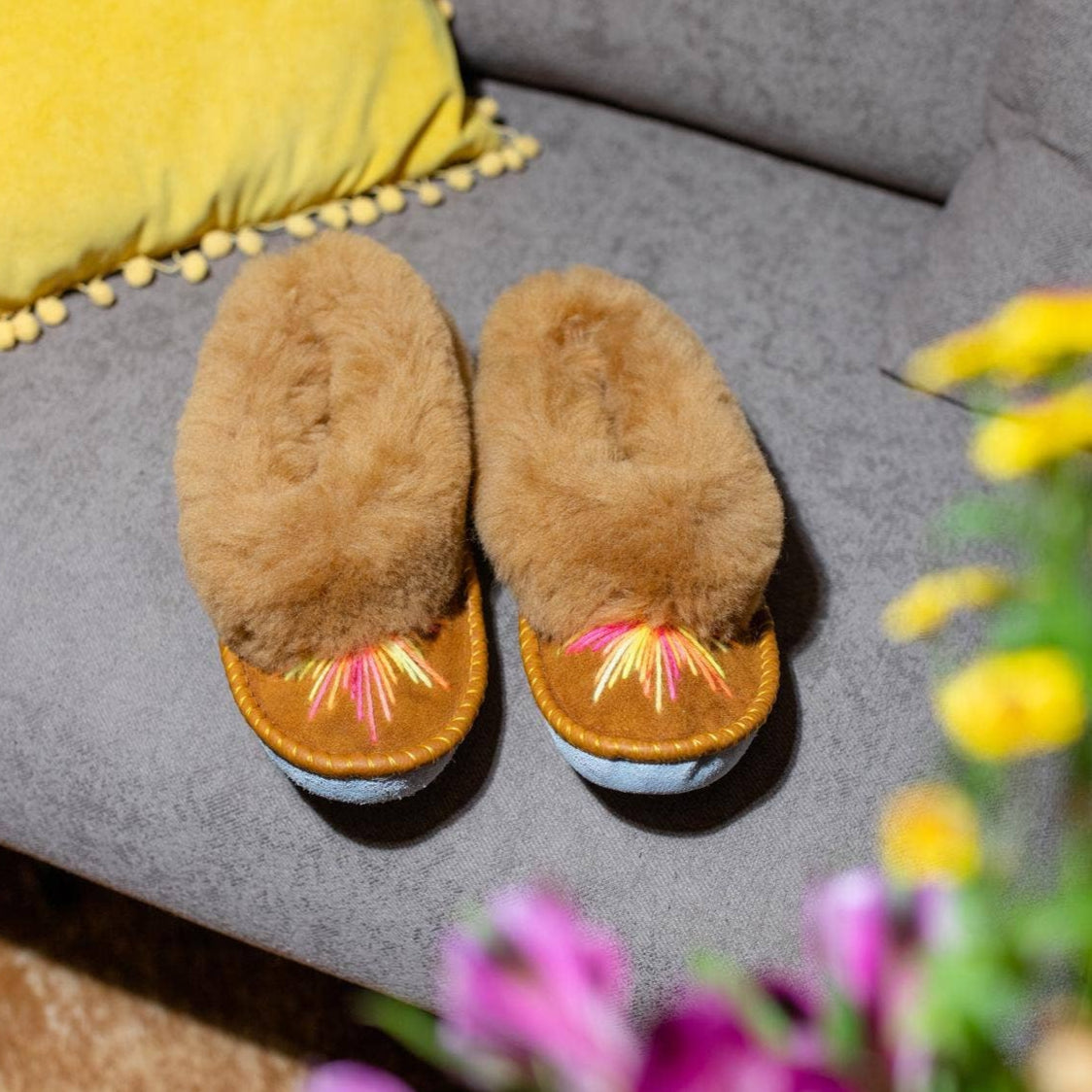 Brown slippers on a grey sofa 