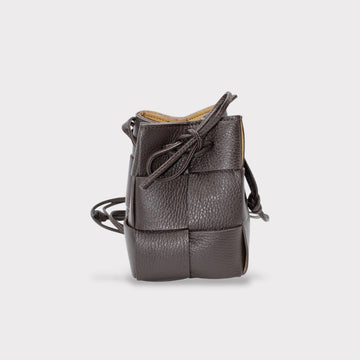 a brown woven leather handbag on a white background 