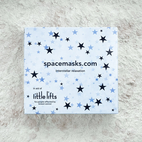 Box of spacemasks with star pattern on a textured surface