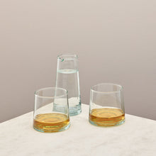 Load image into Gallery viewer, Two glasses filled with whiskey and jug filled with water on a taupe background
