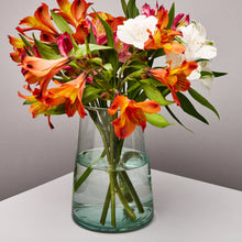 Load image into Gallery viewer, Clear glass vase with colorful flowers on a neutral background
