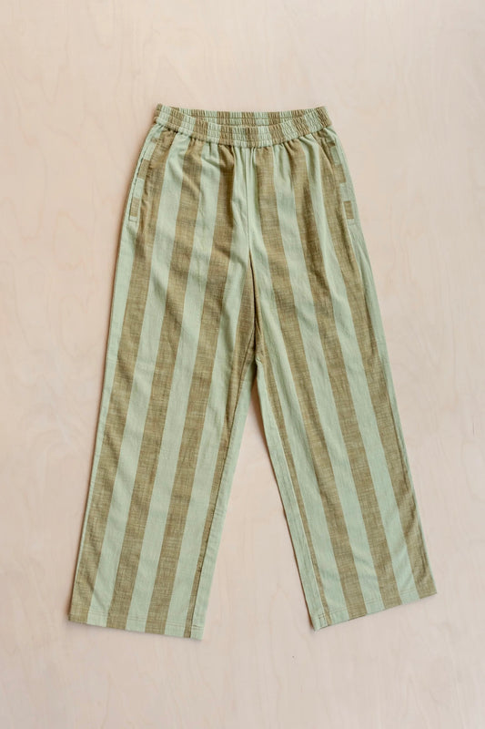 Striped trousers with green and brown pattern on a beige background