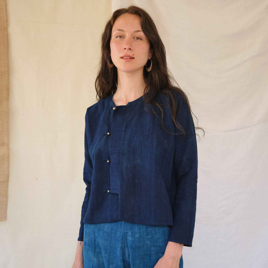 Woman wearing a blue outfit against a plain background