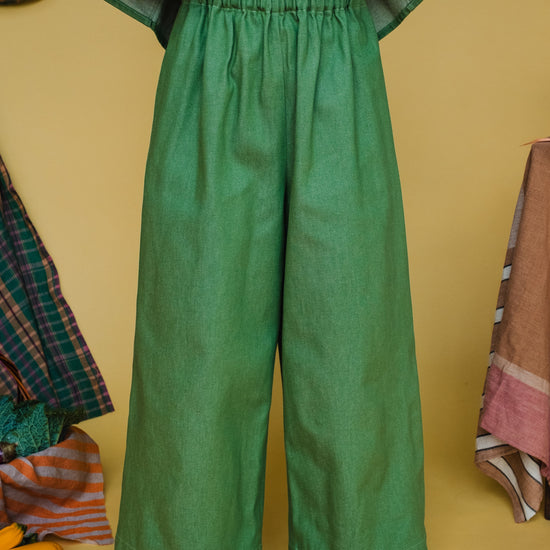 woman wearing green wide leg trousers