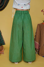 Load image into Gallery viewer, Green wide-leg pants worn by a person on a yellow background
