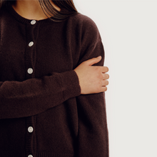 Load image into Gallery viewer, Brown cardigan with button details worn by a person on a white background
