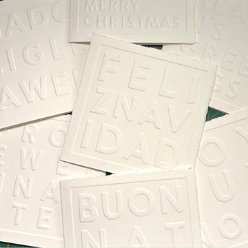 White greeting cards with embossed text on a white background