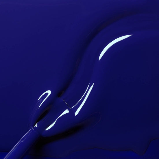 navy blue liquid nail varnish with a brush in situ