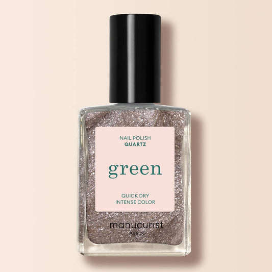 a brown shimmery nail varnish on a cream background 