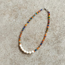 Load image into Gallery viewer, Pearl and seed bead neckalce in multicolour on a beige background
