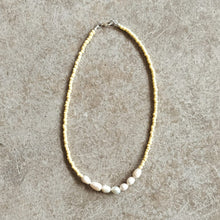 Load image into Gallery viewer, Pearl annd glass bead necklace in butter yellow on a beige background

