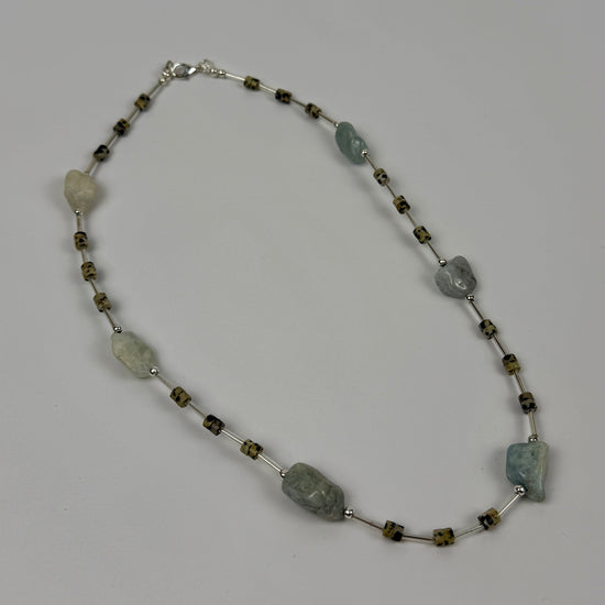 Necklace with natural stone beads on a grey background