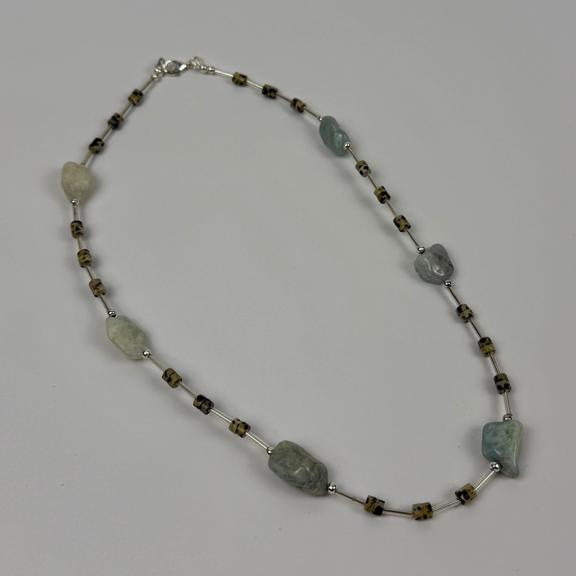 Necklace with natural stone beads on a grey background