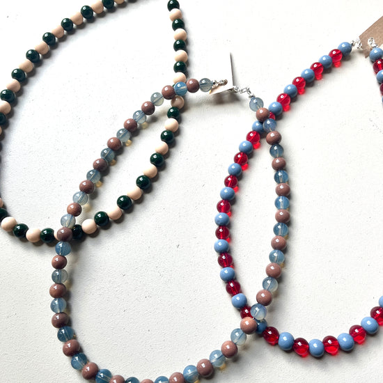 Three glass beaded necklaces on a white background