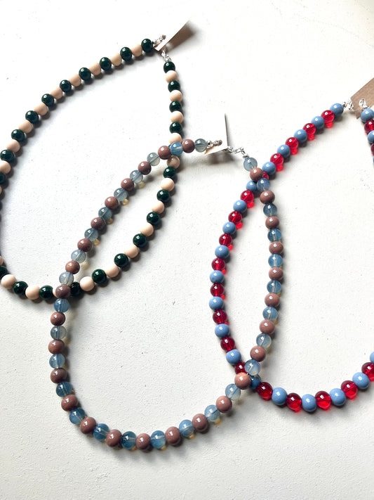 Three glass beaded necklaces on a white background