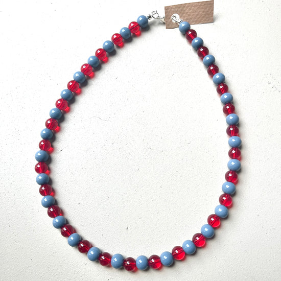 Necklace with red and blue beads on a white background