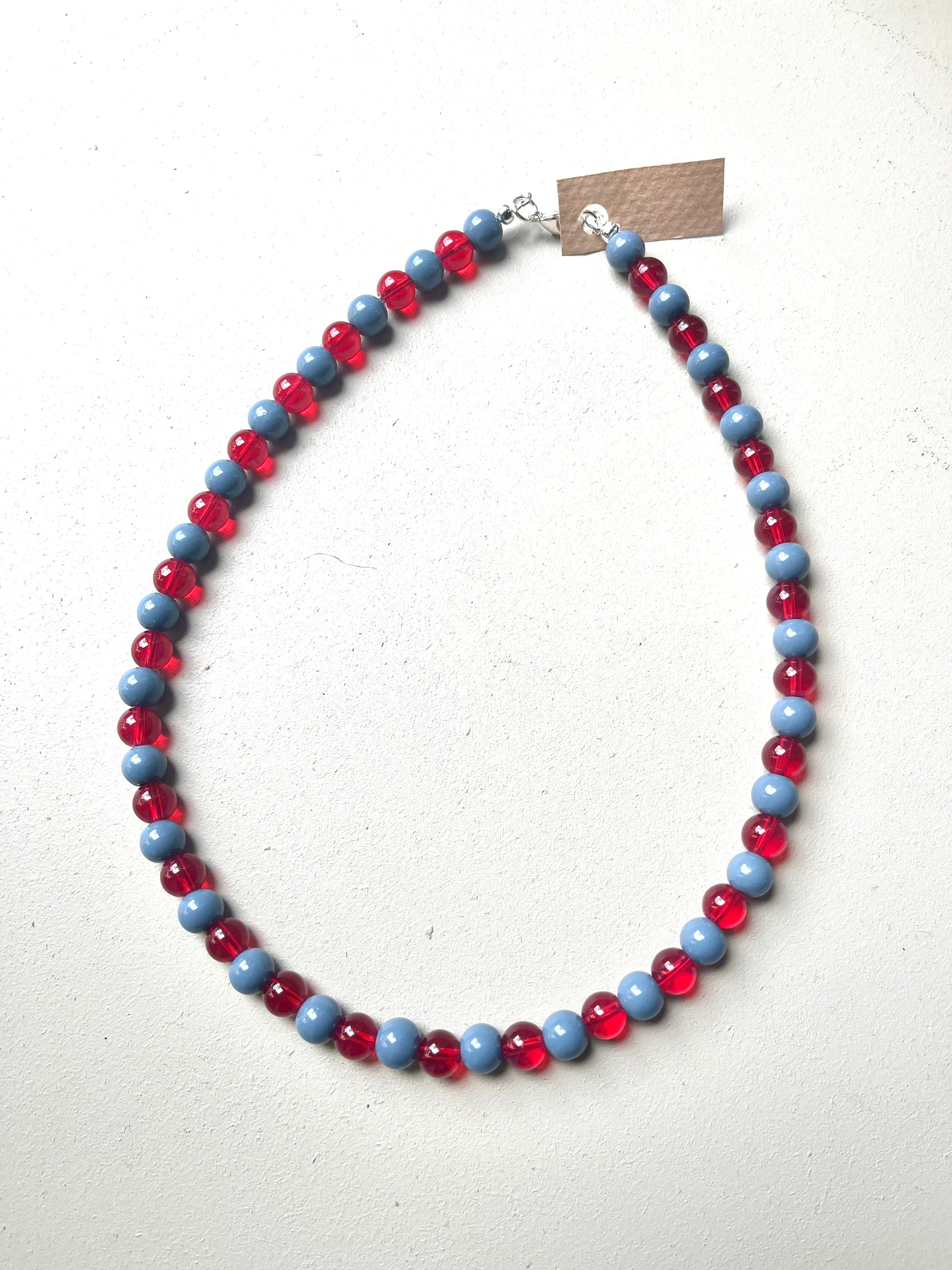 Necklace with red and blue beads on a white background