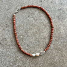Load image into Gallery viewer, Beaded necklace with brown beads and a silver clasp on a gray surface
