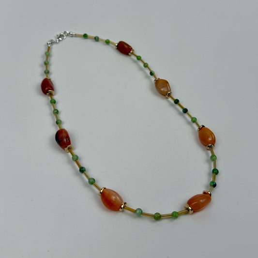 Necklace with multicolored beads on a light gray background