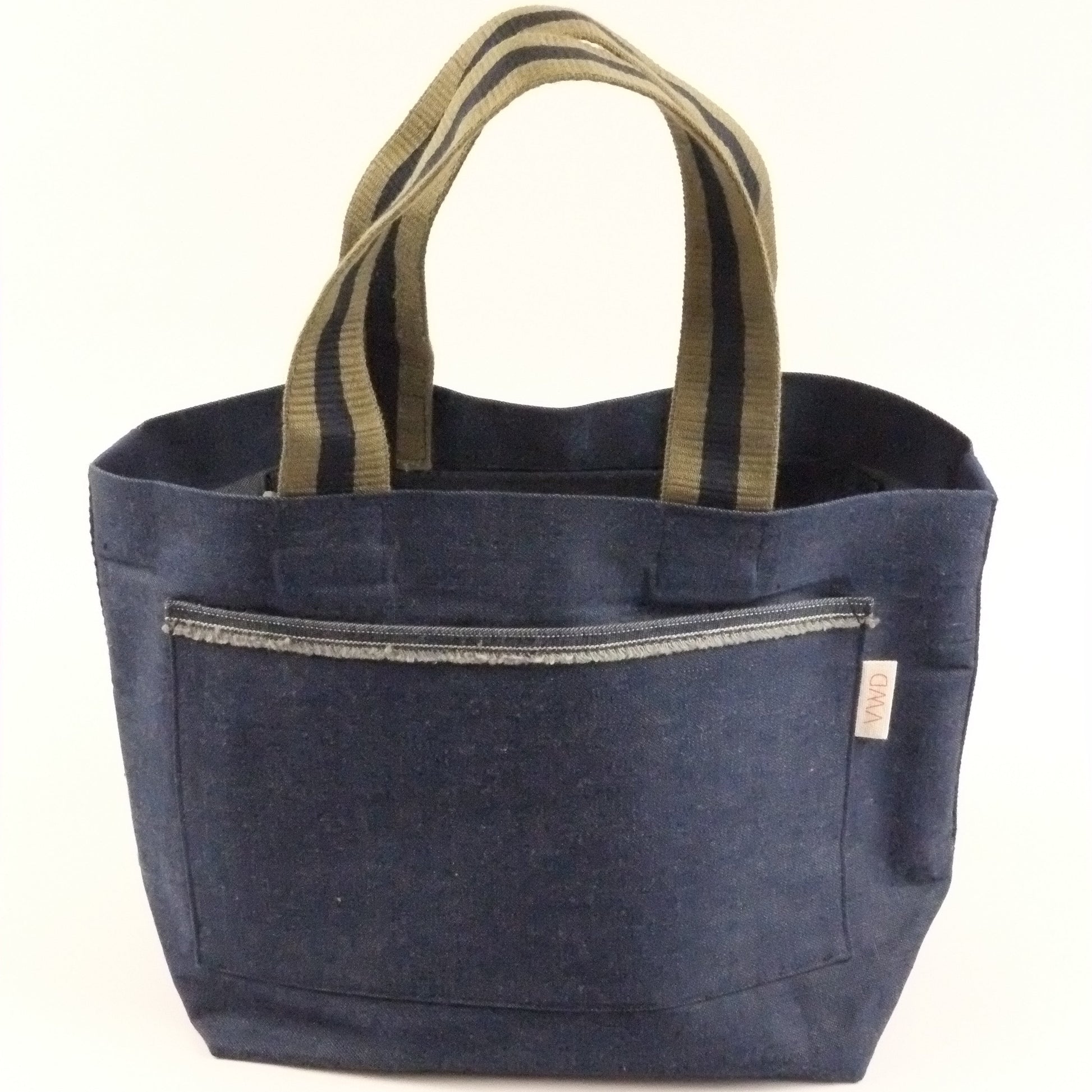 Blue tote bag with striped handles on a white background