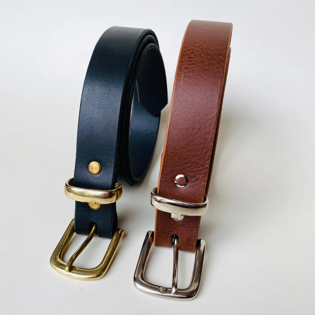 Two leather belts, one black and one brown, with gold and silver buckles on a white background.