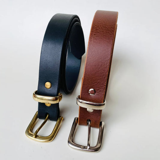 Two leather belts, one black and one brown, with gold and silver buckles on a white background.
