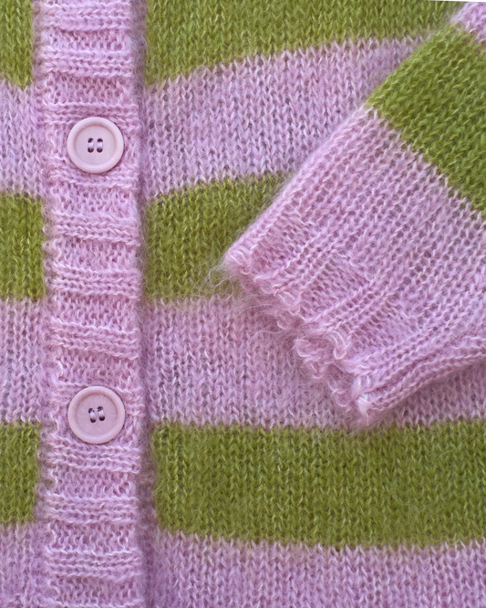 Close-up of a knitted cardigan with horizontal light pink and olive green stripes, featuring a ribbed button placket with pale pink buttons and a folded cuff.
