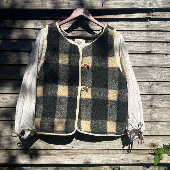 Black and white top with sleeves on a wooden surface