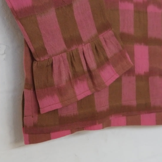 frilly fabric with pink and brown checkered pattern on a white background