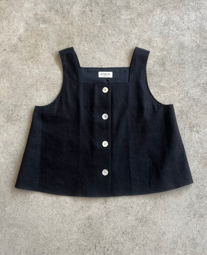 Black sleeveless top with shell button details
