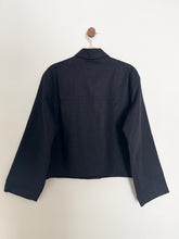 Load image into Gallery viewer, Black jacket on a hanger against a white background
