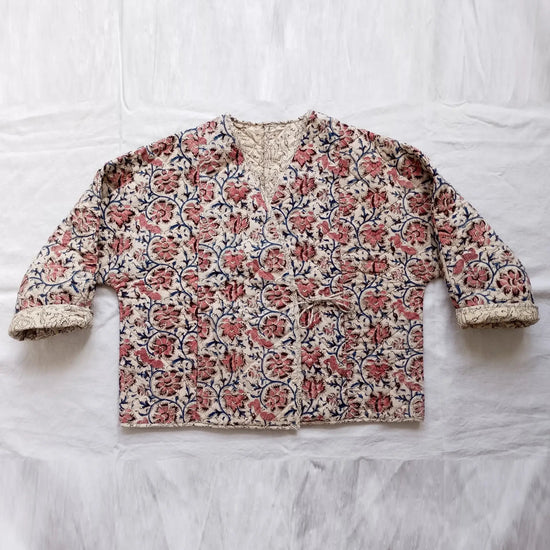 Floral patterned jacket on a white fabric background