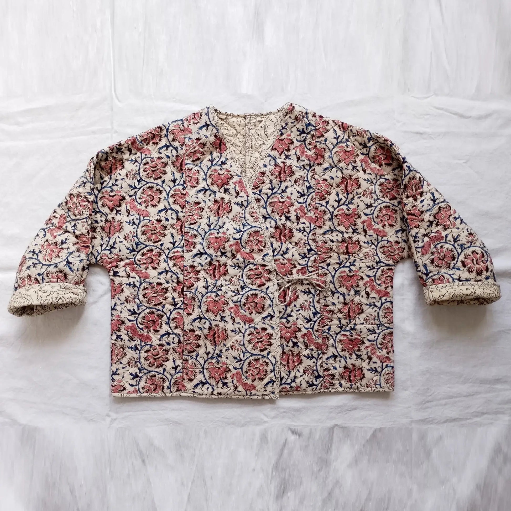 Floral patterned jacket on a white fabric background