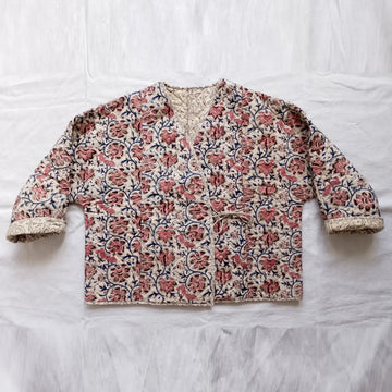 Floral patterned jacket on a white fabric background