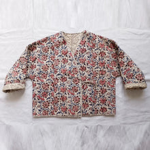 Load image into Gallery viewer, Floral patterned jacket on a white fabric background

