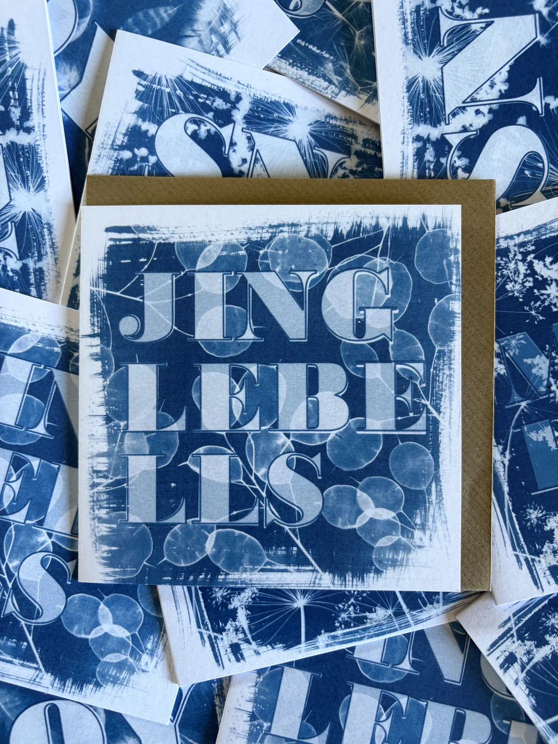 Card with 'jingle bells' text on a blue patterned background